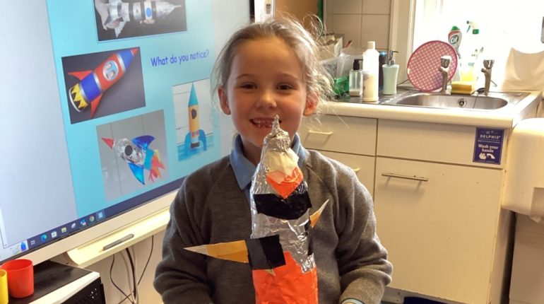 student showing foil rocket creation