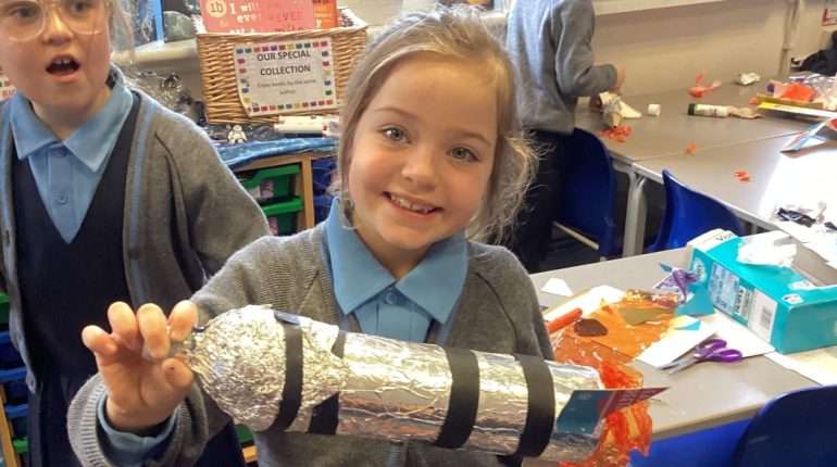 child with foil rocket