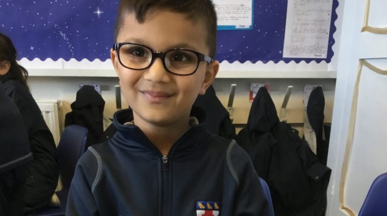 child wearing glasses in their uniform